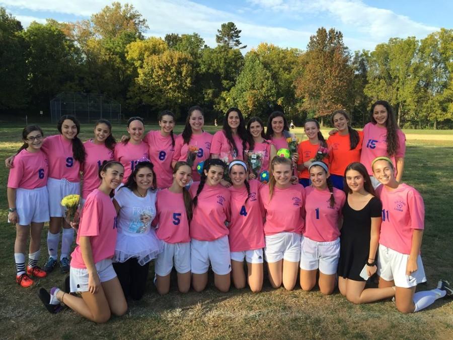 The girls varsity soccer team in their pink jerseys before their game against the Washington Waldorf School. The team chose to purchase the jerseys to raise awareness for breast cancer during the month of October.