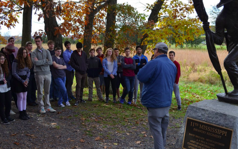 Seniors listen to a tour guide in front of the memorial for Mississippis 11th Infantry Regiment. 