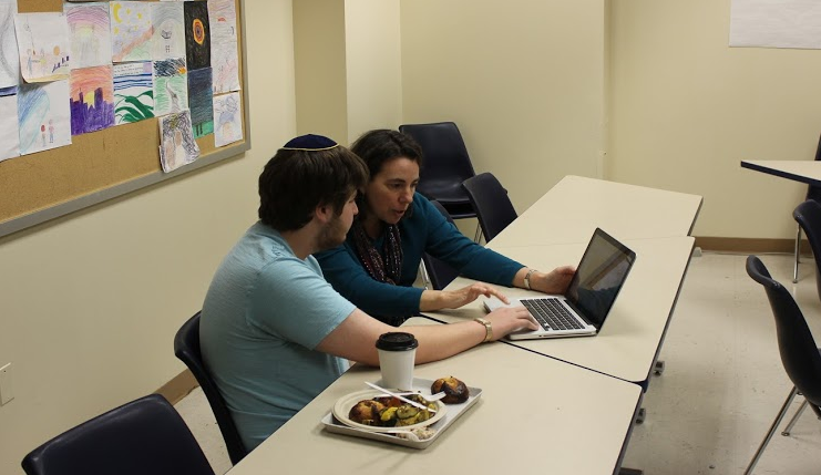  Junior Eli Winkler works on an ISearch draft with English Teacher Melissa Fisanich in the Writing Center.