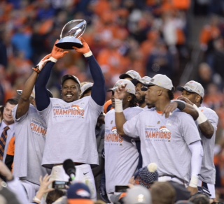 Broncos outside linebacker Von Miller hoists the Lamar Hunt trophy following Denver's 20-18 win in the AFC Championship game against the New England Patriots on Sunday, Jan. 24, 2016, at Sports Authority Field at Mile High in Denver. (Mark Reis/Colorado Springs Gazette/TNS)