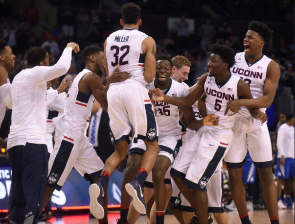 The University of Connecticut mens basketball team celebrates their American Athletic Conference tournament championship on Sunday, March 13 in Orlando, Fla. 