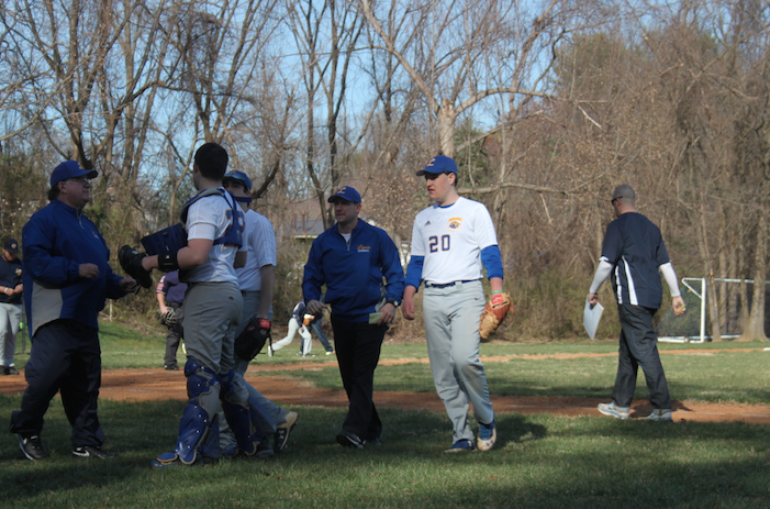 Members of the Lions varsity baseball team congregate after a successful inning during their first game of the season on Tuesday, March 22.
