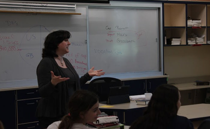Jewish text teacher Rabbi Janet Ozur Bass engages in discussion while teaching her eighth grade class.