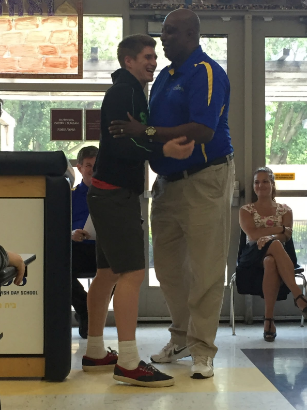 Junior and varsity basketball player Bryan Knapp embraces his coach, Dave McCloud, after receiving the Lion’s Award. This is the second straight year Knapp has won the award for the team. 