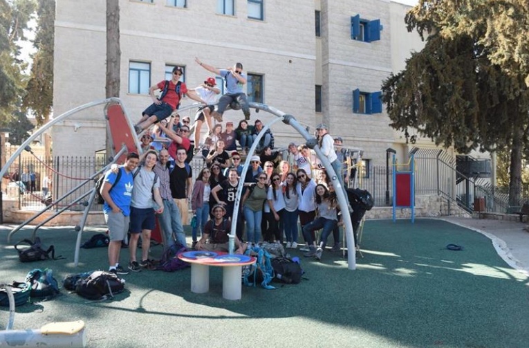 Students in the Class of 2016 climb on playground equipment in Tzfat during their capstone Israel trip.