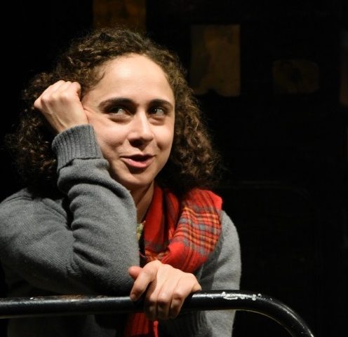 Anne Frank, played by Carolyn Faye Kramer, sits on her sister Margot’s bed thinking about life outside the annex. 