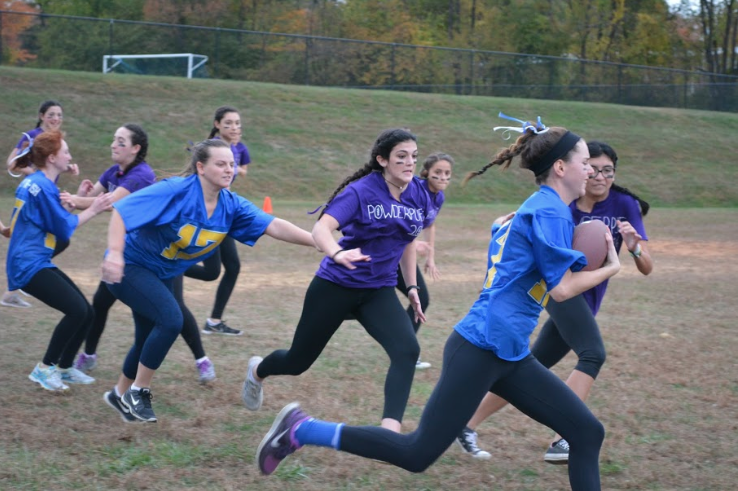 Senior Sara Hughes races down the sideline as she tries to evade defenders. Hughes would later score one of the senior team’s two touchdowns. 

