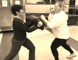 Krav Maga class participants practice their self-defense skills in the Upper School cafeteria on Nov. 9. 