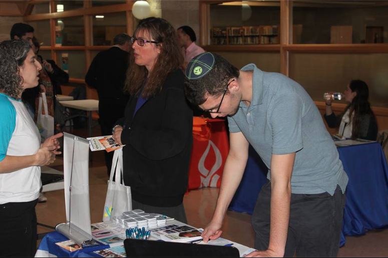Junior Jonah Loshin learns about the Aardvark Israel
gap year program. Alumni and representatives from 25
different gap year programs came to JDS on Nov. 15 from 6:30-8:30 p.m.