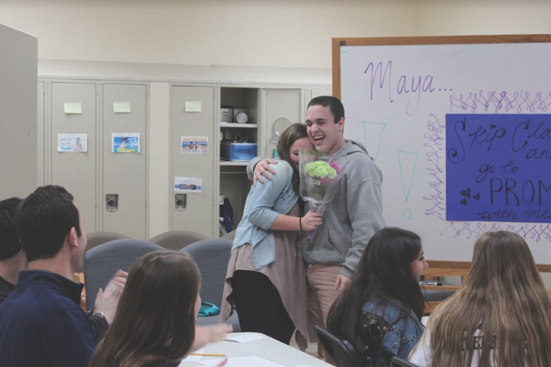 Senior Maya Arber celebrates with her Prom date, senior Nathan Rodney, after his promposal in
the senior alcove. Rodney and Arber’s close friends took part in the classroom-themed skit. 