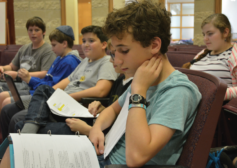 From left: Eighth-grader Drew Sadikman, seventh-grader Zach Arking, seventh-grader Isaac Odintz, seventh-grader Ari Cribbs, eigth-grader Jonathan Morris and seventh-grader Avigayil Fischman-Charry study their scripts during rehearsal.