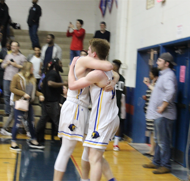 Seniors Bryan Knapp and Nadav Kalender hug following their championship win. Only three players on the boys varsity basketball team are underclassmen this year, so coach Dave McCloud will be coaching fresh faces next season.