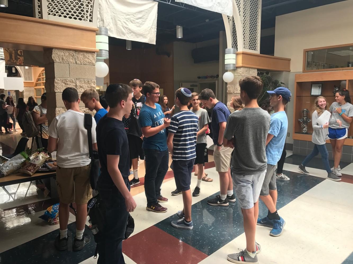 Incoming students and their student buddies get to know each other outside the Beit Midrash before the orientation begins.
