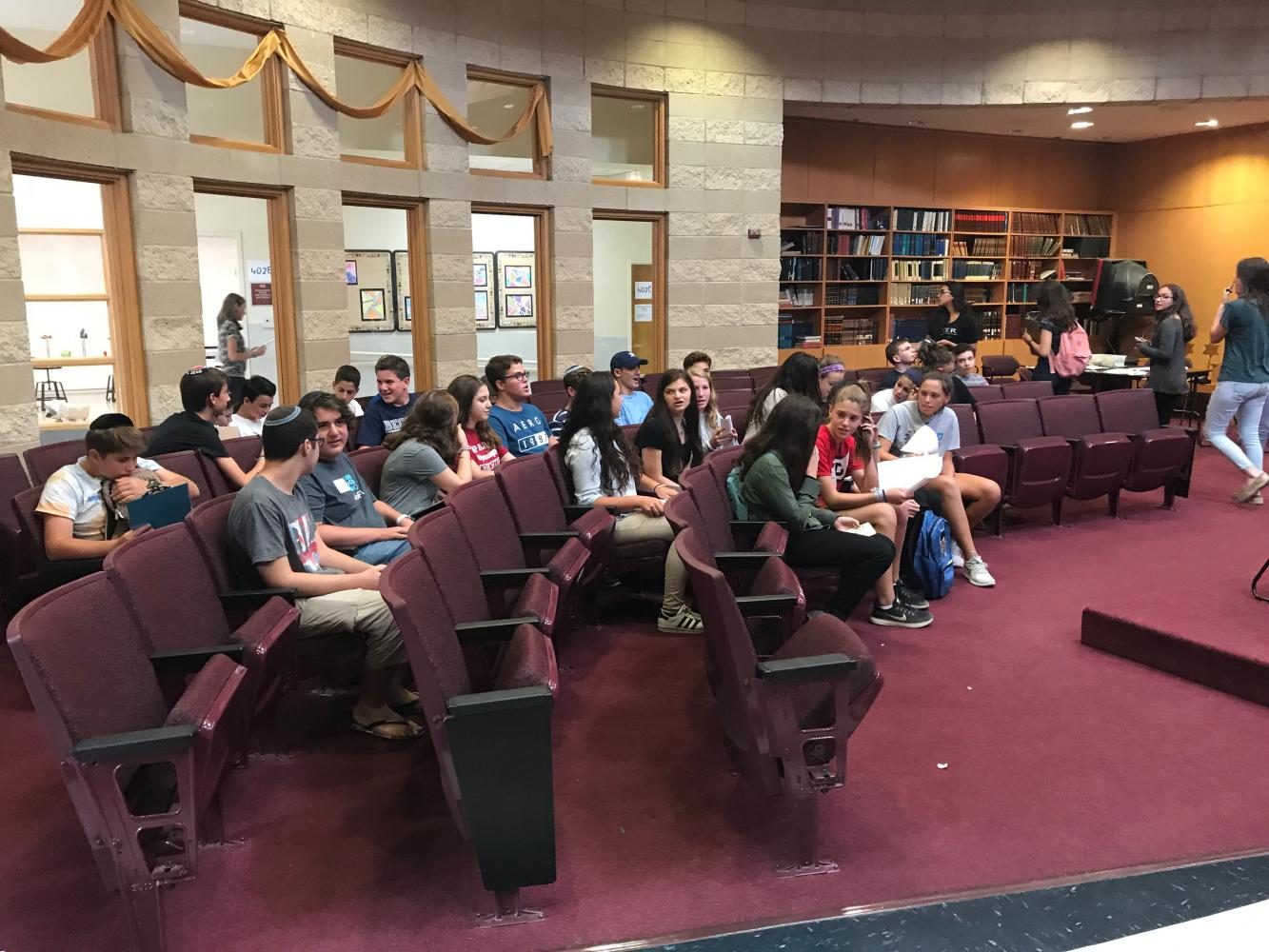New students and their buddies gather in the Beit Midrash to begin their orientation activities. The student buddy system allows new students to adjust socially.
