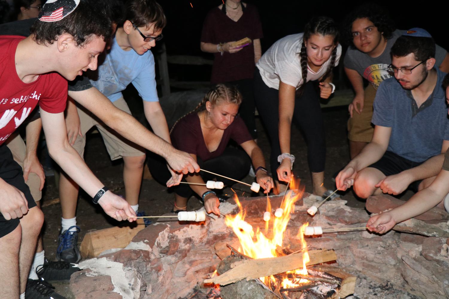 Senior gather around the campfire to roast marshmallows, as part of the barbecue social that took place Sunday night. The seniors headed inside afterwards for a student-led