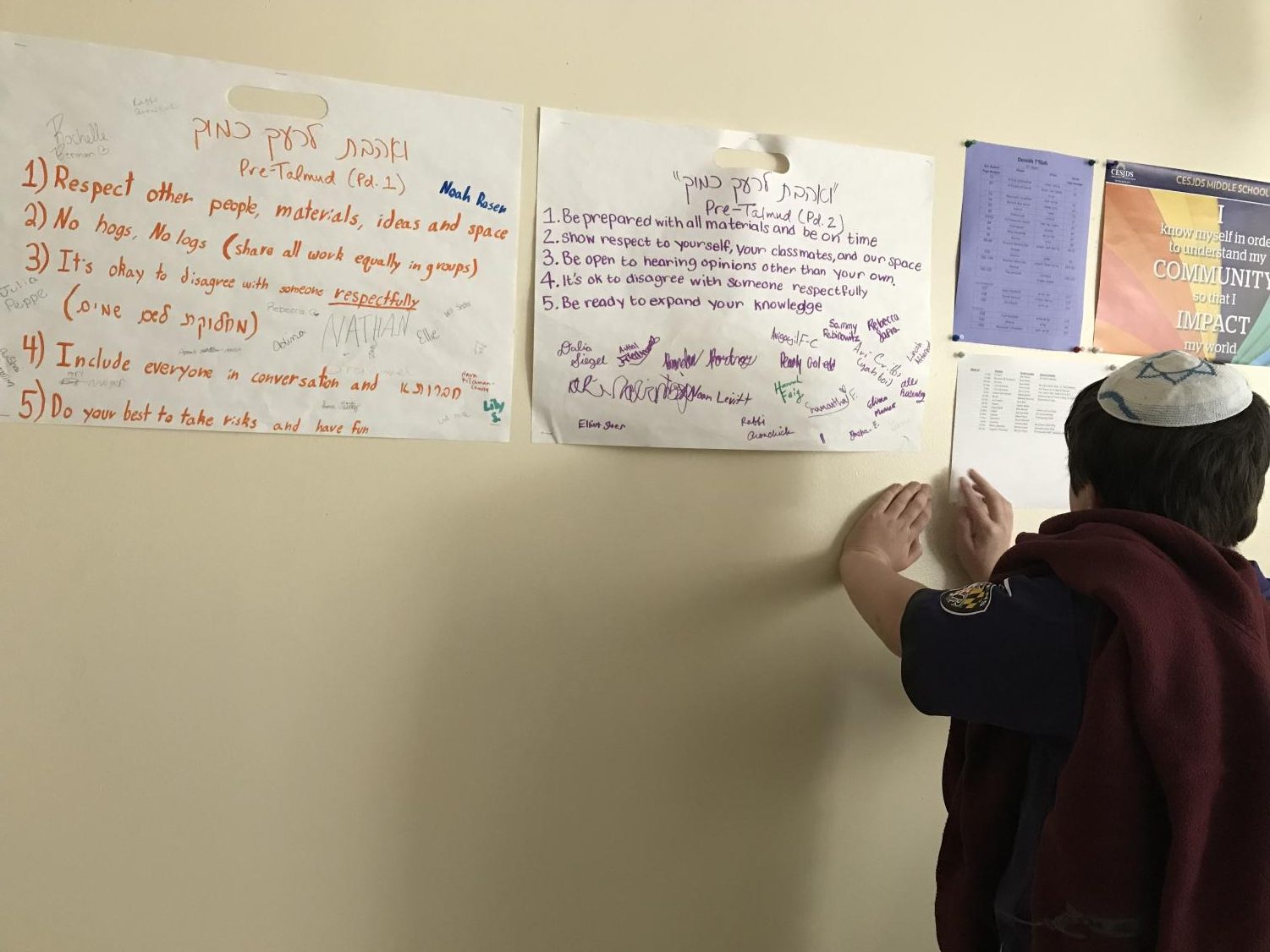 One middle school student works on determining how the phrase “V'Ahavta Le'Rei'akha KamoKha” can translate into everyday school situations. The session explored the implications of loving one’s neighbor as one loves oneself.
