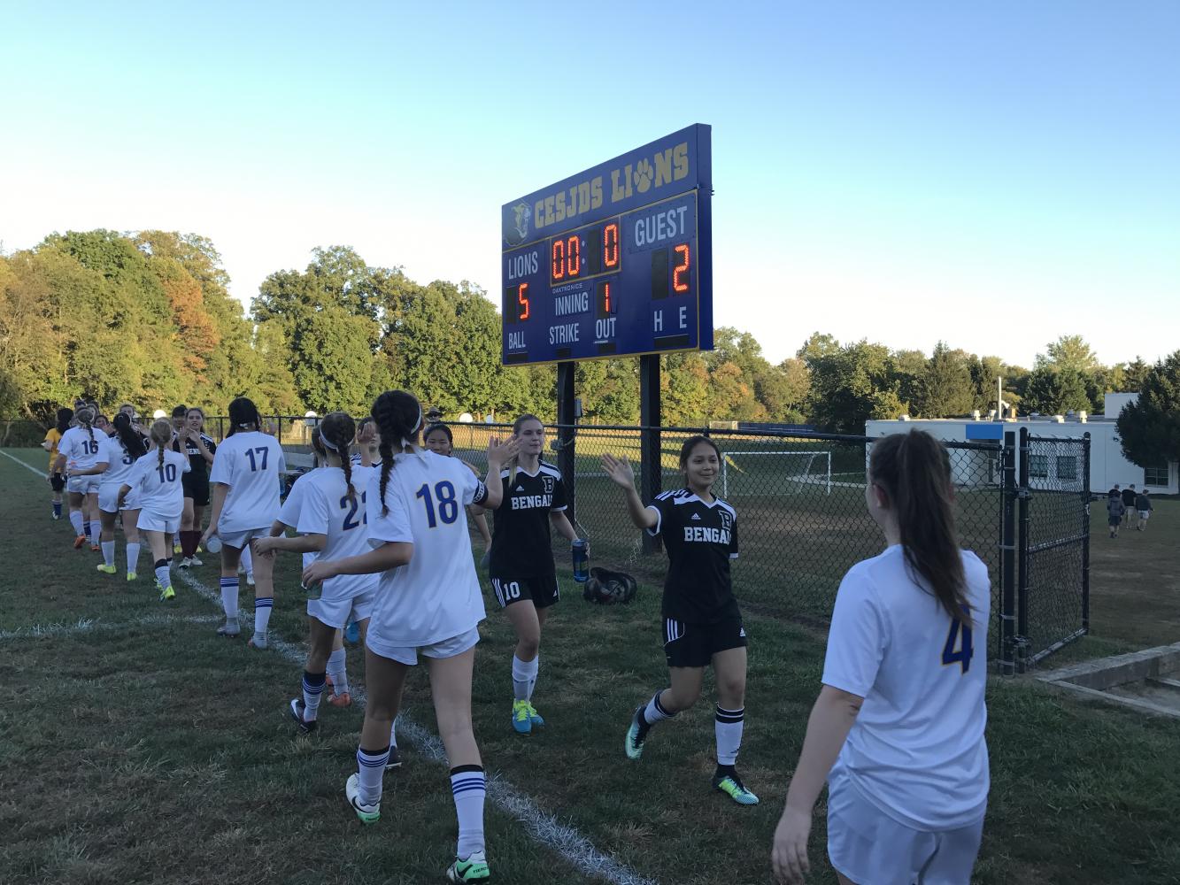 The Lions shake hands with the Burke Bengals at the end of their game at CESJDS on Tuesday. The Lions defeated the Bengals 5-2.