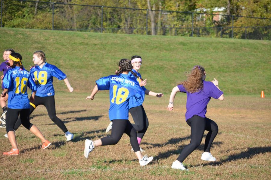 Senior girls run after the junior team as the latter attempts to catch a pass. The junior offense was anemic all game as the seniors got a shut out.