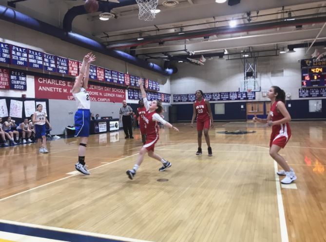 Eighth-grader Zoe Fischman shoots a jump shot in the third quarter to advance to Lions’ lead. Fischman was the Lions’ leading scorer, finishing with 14 points.
