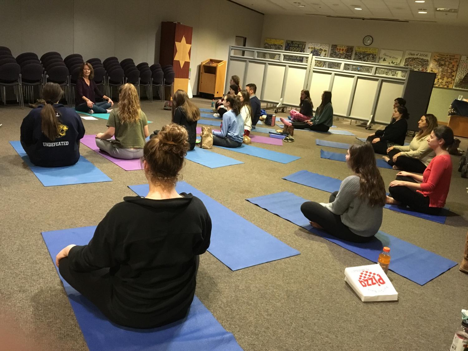Students and faculty practice yoga poses in a yoga workshop during lunch and Community Time. It was the third part of the school's wellness series, which also included dog therapy and hypnosis sessions.