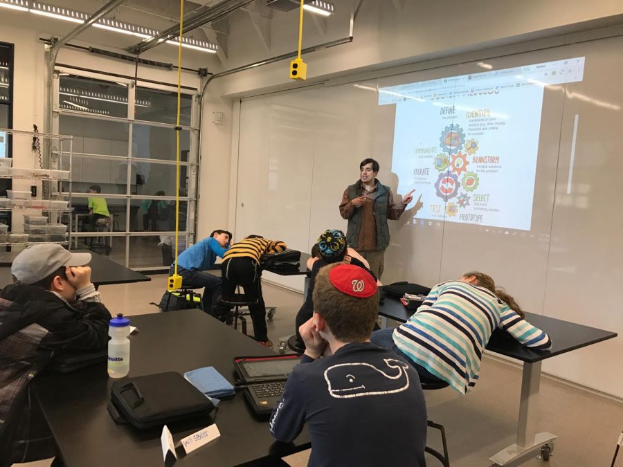 Meyer introduces a new project for middle school students who are taking coding this semester; the project involves following a list of procedures that are projected on the board.