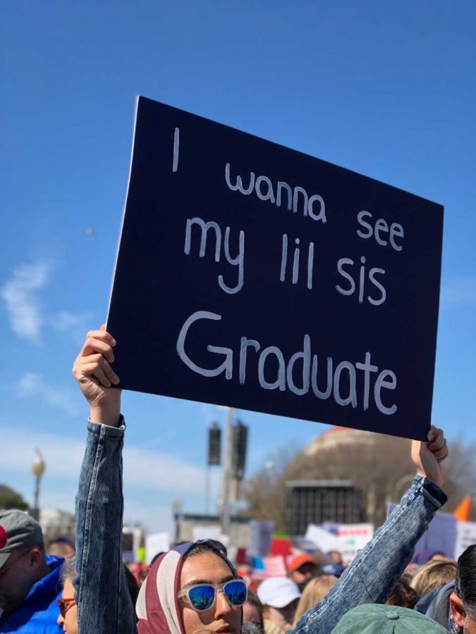 A women proudly holds up her sign as she participates in the rally. 