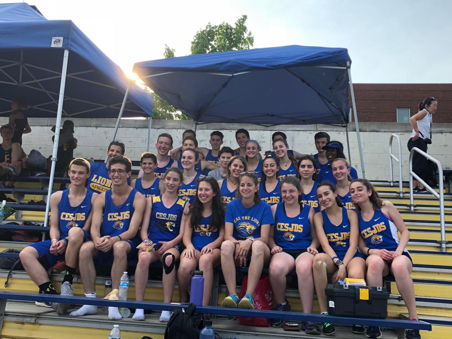 The varsity track and field team poses for a team picture at their championship meet.