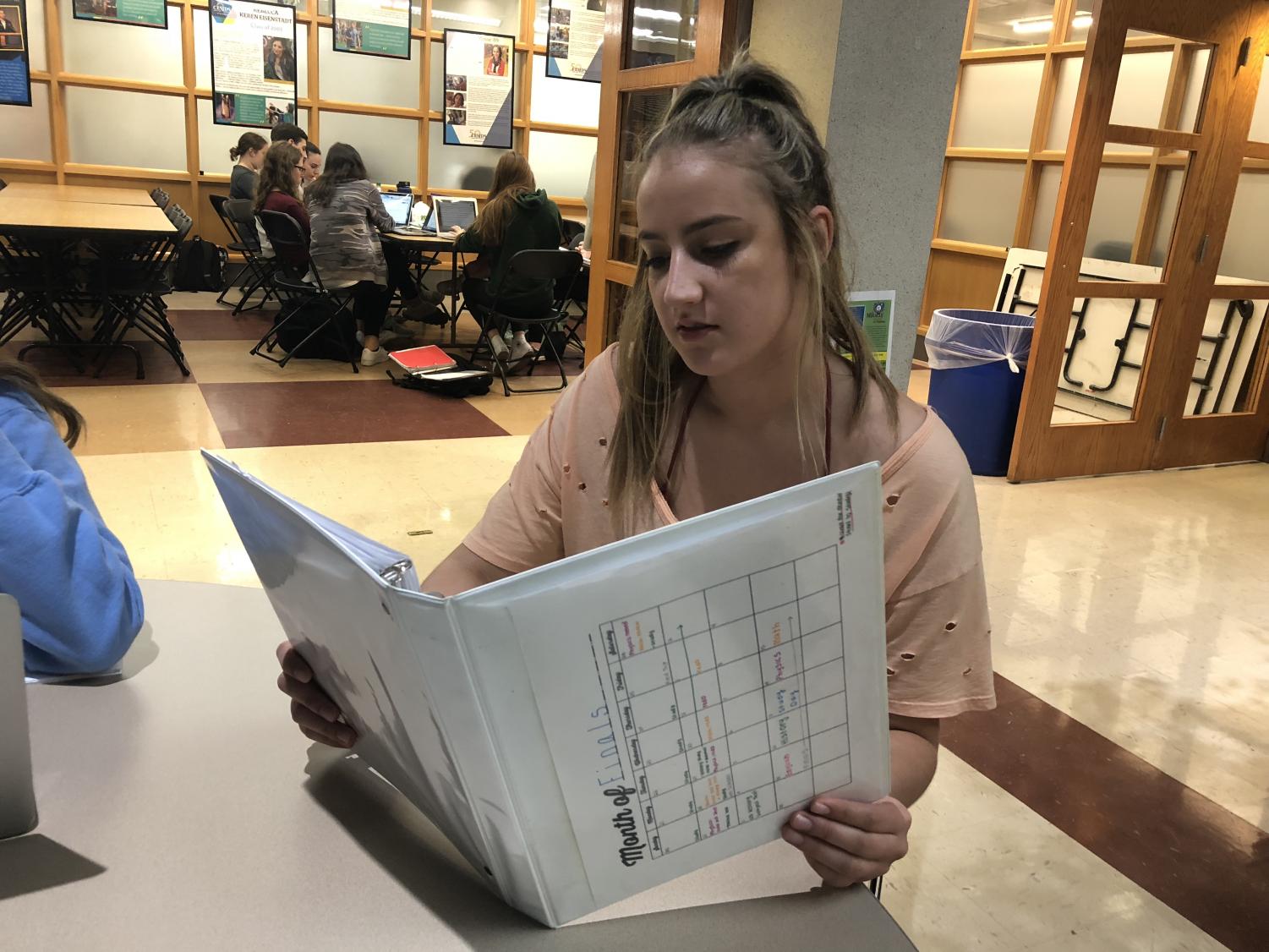 Junior Natalie Buckwold starts preparing for this year's final exams using a review binder. This year's final exams will count for less than previously.