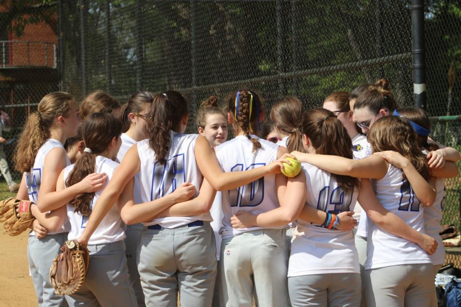 The girls softball team huddles before their game against Edmund Burke, in the PVAC semifinals.