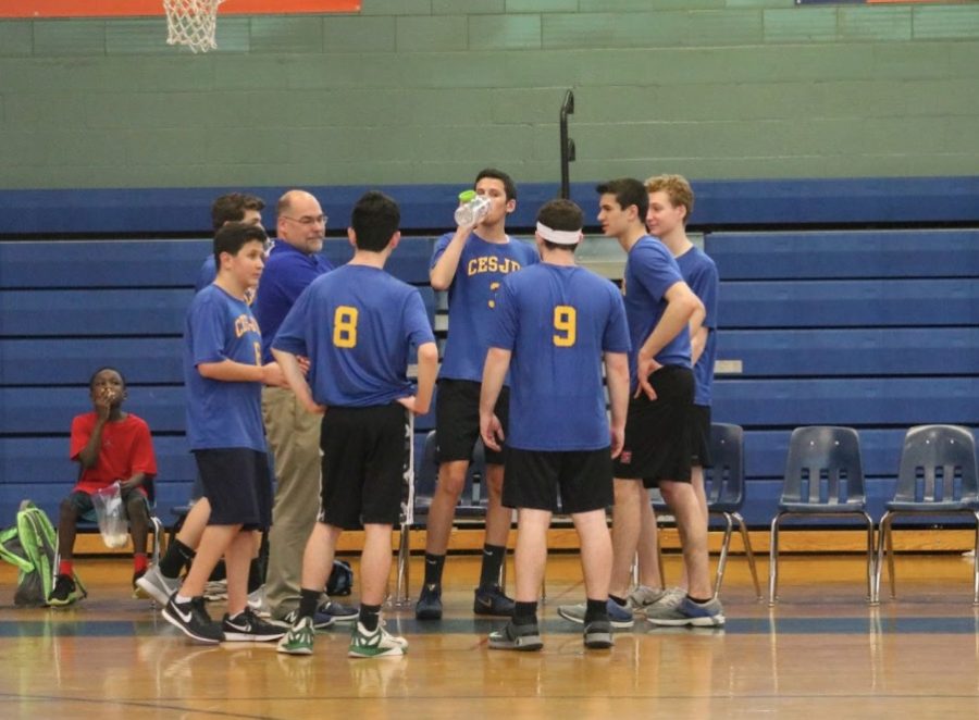 During a timeout at Hebrew Academy game, the team gathered together.