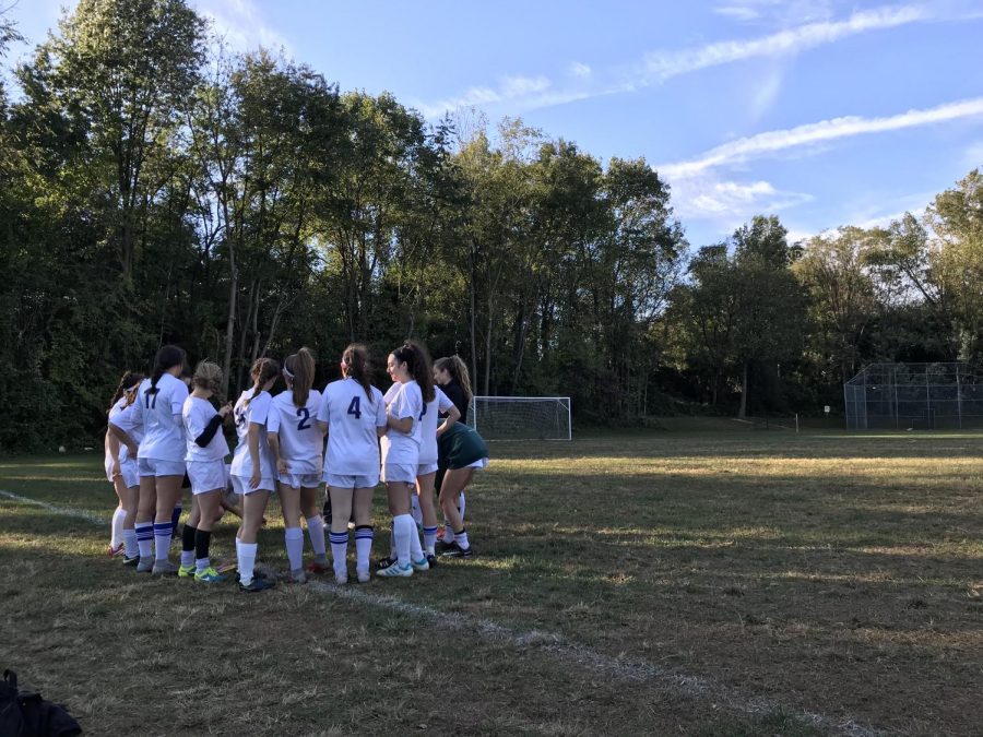 Girls varsity Soccer gathers to discuss strategies, prior to the game. 