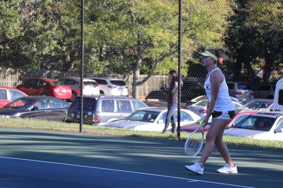 Junior Gigi Becker serves the ball to her Field School opponent in the last regular season match of the girls varsity tennis season. This season the girls beat Oakcrest twice, lost to WIS twice, but managed to secure the win over Field. 