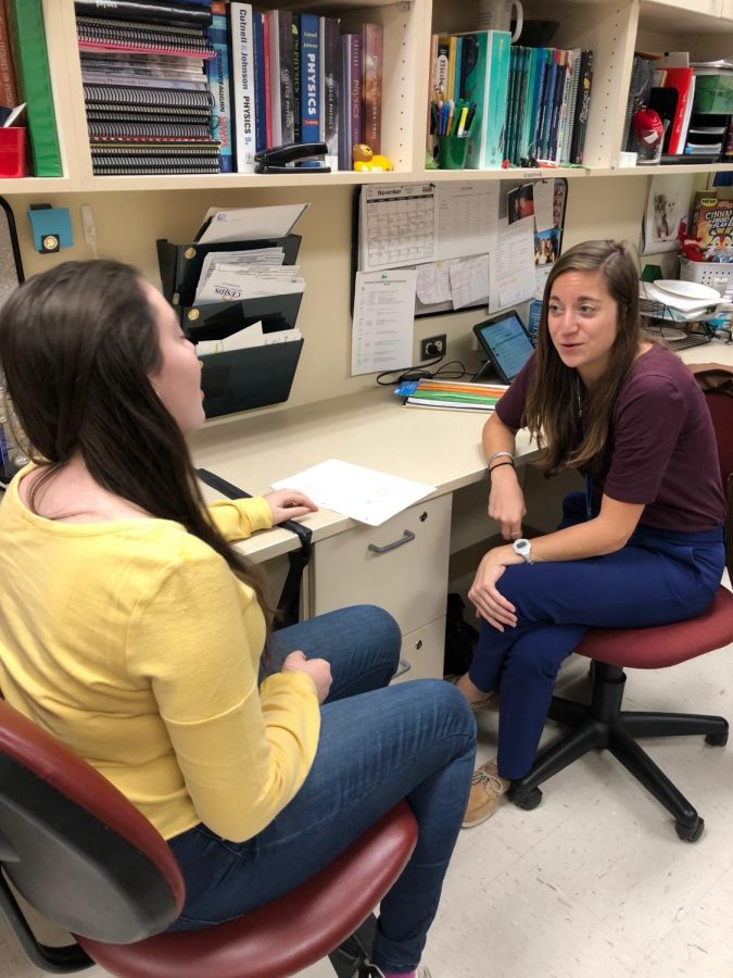 Science teacher Kelly Grosskurth speaks to a student about their class.