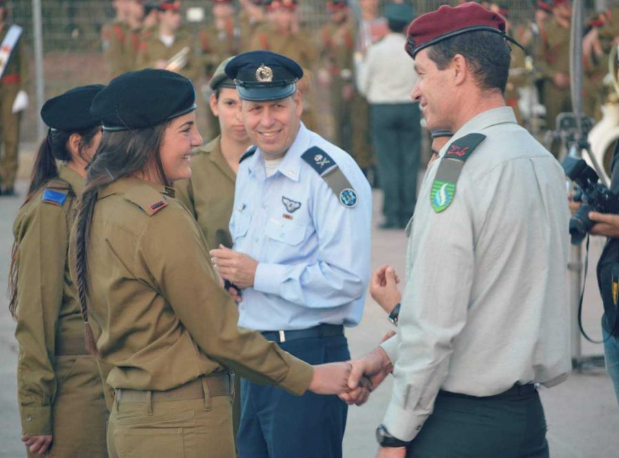 Tal Greenberg (pictured front-left) shakes hands with high ranking officers after she completed her officer course and received her new, commissioned rank. It was a moment she said she will “probably never forget.”