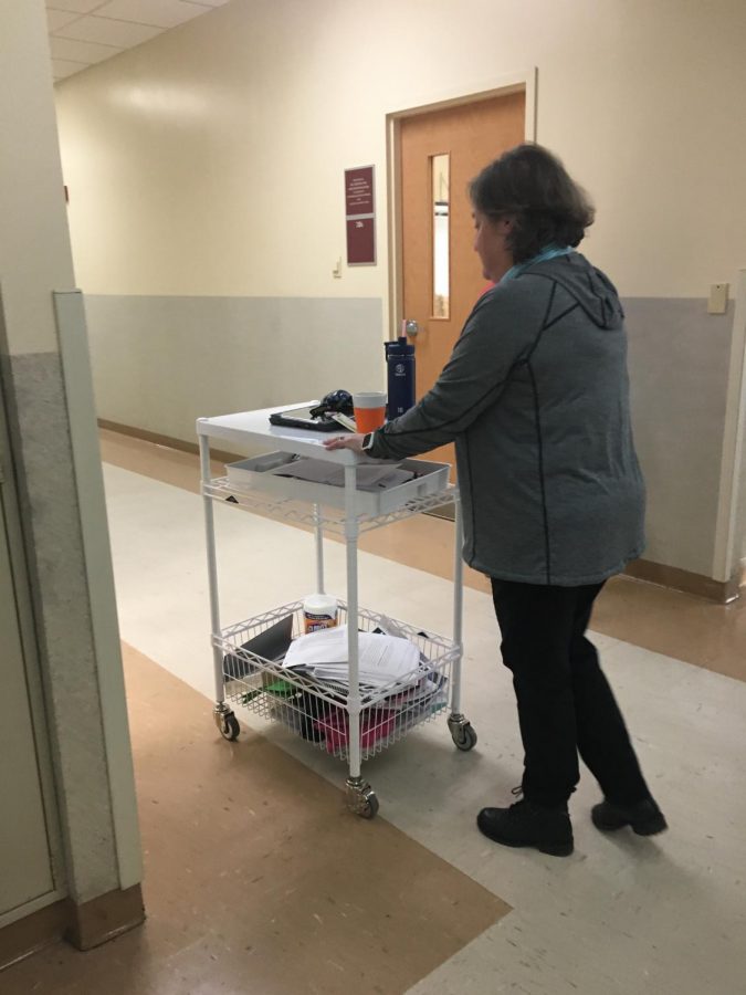 Jewish history teacher Sara Coxe uses a cart to present in front of her classes and store her materials.