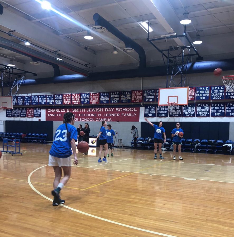 Alumna Paige Siegel (‘12) warms up with other alumni before the game. “I got the emails from the Alumni Association and saw that they were having an alumni game and I thought ‘I can’t not play,’” Siegel said.