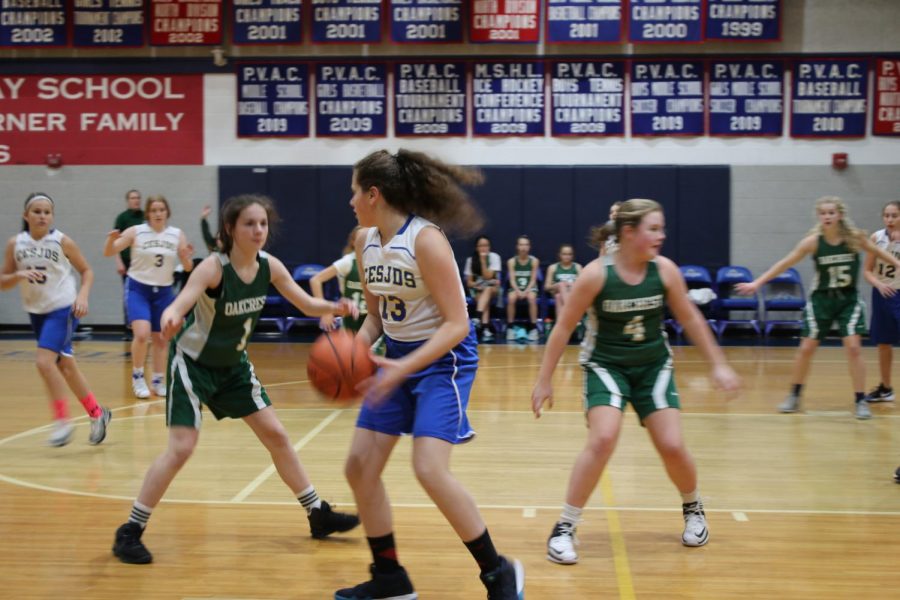 Seventh-grader Ellie Fischman escaped from a trap by Oakcrest to pass the ball back to the top of the three point arch. 
