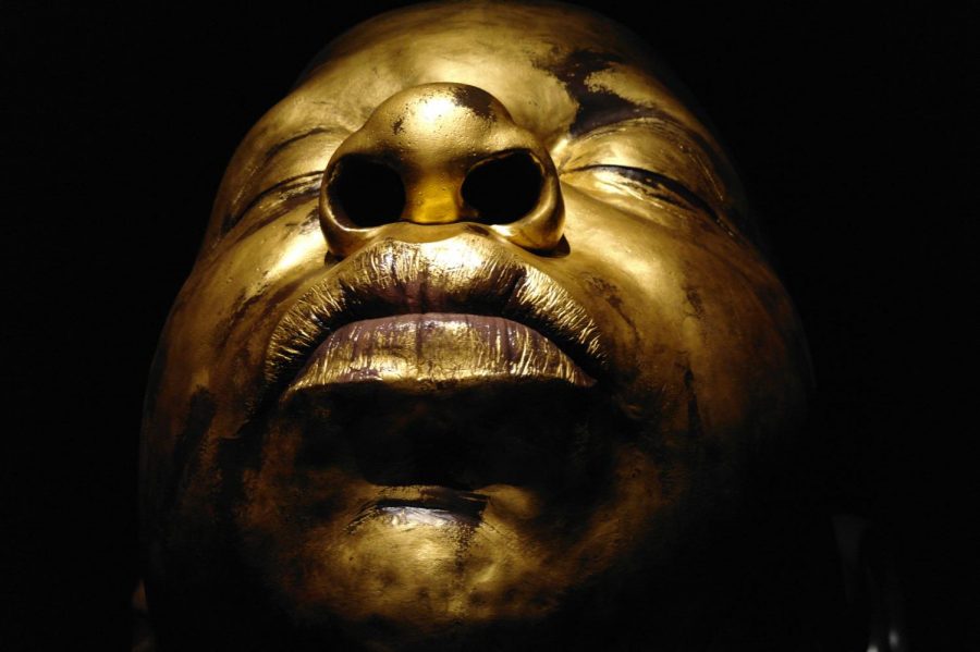 A golden bust, as tall as the ceiling, takes up an entire room in the exhibit.