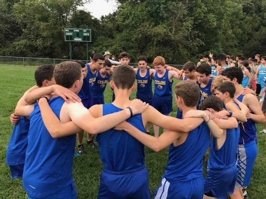 Varsity+cross+country%3A%0A%0ARunners+huddle+together+moments+before+a+meet+at+the+Sandy+Spring+Friends+School.