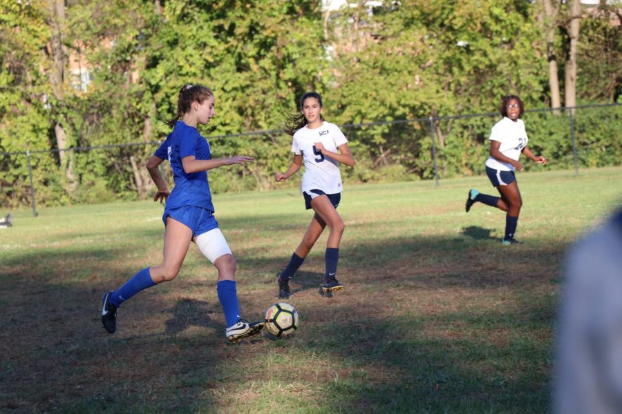 Junior Ally Knapp dribbles the ball around her opponent in a game. 