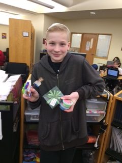 Seventh-grader Sean Levitan, the “Poem In Your Pocket Game” champion, poses with his prizes: a 40 dollar Barnes and Noble gift certificate and two “rhyming prizes” that were based on rhyming words. Although not the last person standing, Levitan won because he was the only middle schooler remaining when the game ended due to time constraints. 
