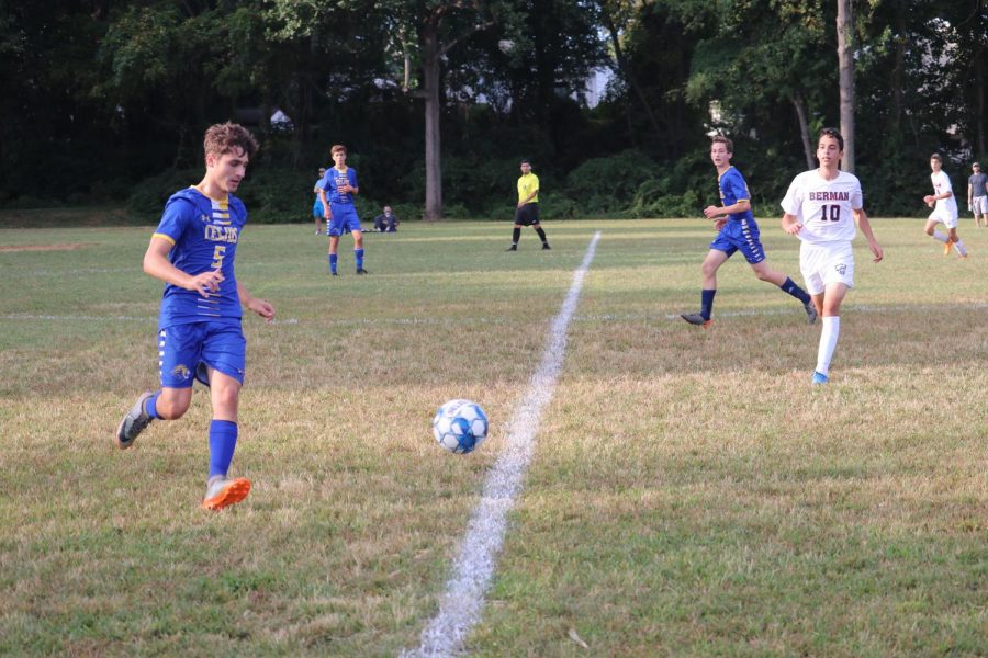Senior co-captain Yoni Preuss runs after the ball in the boys varsity soccer game Tuesday afternoon.