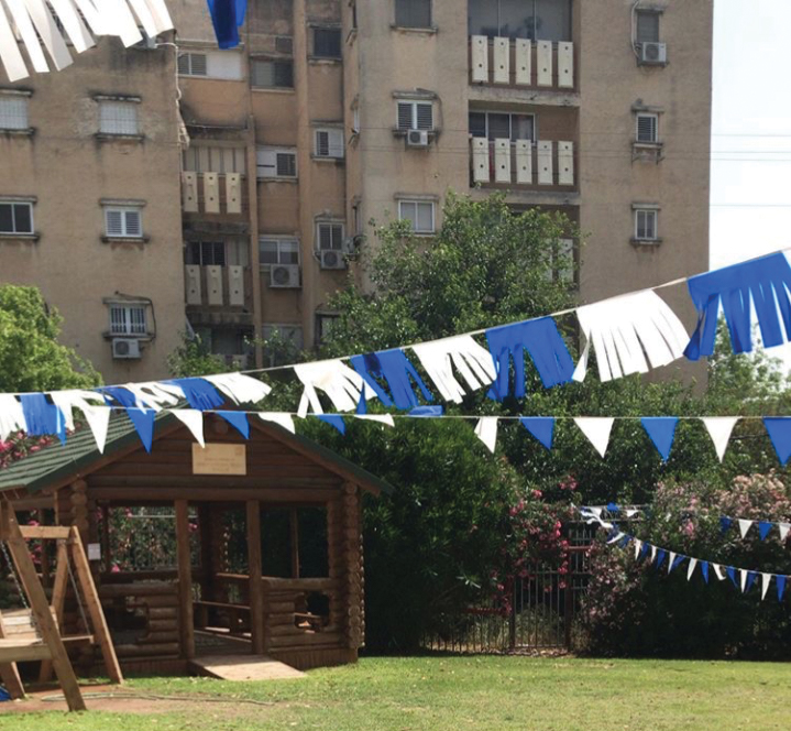 Banners wave in front of one of AMHSI’s dormitories in Hod HaSharon, Israel that CESJDS seniors live in during their capstone trip to Israel.