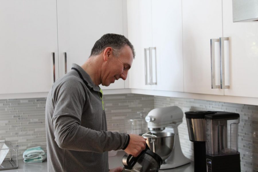 COFFEE TIME:
Malkus smiles while he pours coffee for his family. The coffee is one of the last steps for making the brunch and it is a comforting drink to have on a cold Sunday morning.