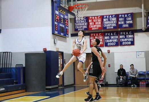 Junior Tyler Farkas attempts a layup in the game.