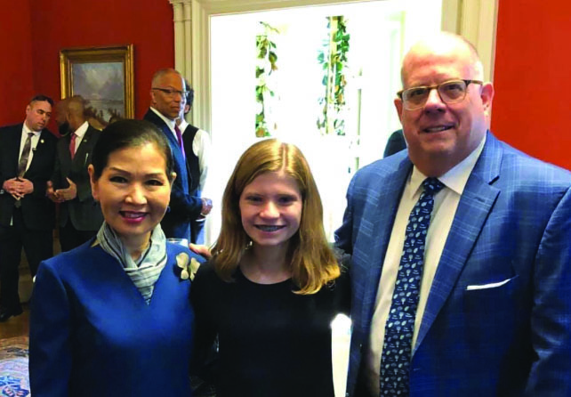 Freshman Kate Morgan [middle] spoke with Maryland Gov. Larry Hogan [right] and Maryland First Lady Yumi Hogan [left] about the Maryland-Israel Sister State Committee at the yearly Hanukkah party hosted by the Hogans on Dec. 15, 2019. 