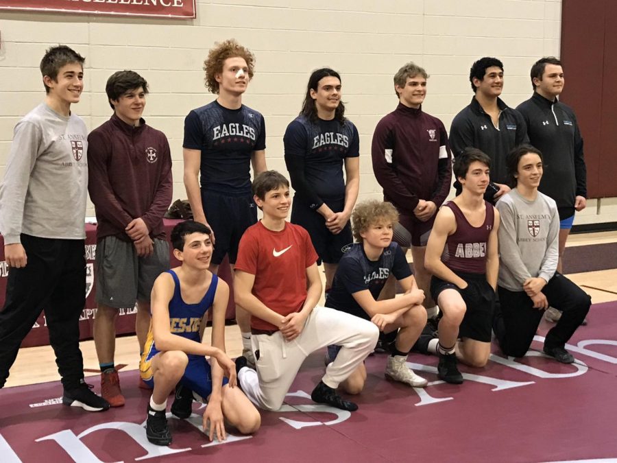 Freshman Oliver Ferber [front left] poses with fellow Potomac Valley Athletic Conference champions after winning his weight class. 