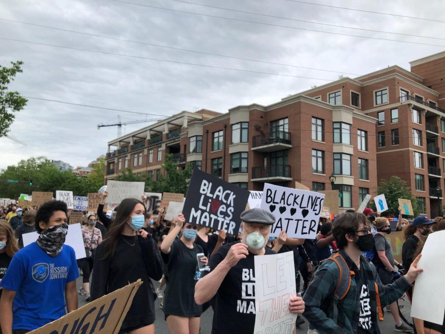 Wearing masks as they march through downtown Bethesda, Maryland, peaceful protesters advocate for racial justice in the U.S.