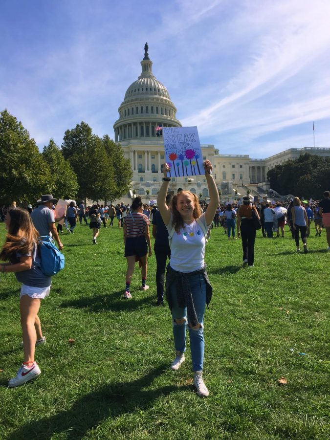 Junior Zoe Wertlieb stands in front of the Capitol during a climate change march. 