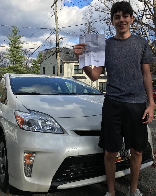 Junior Lincoln Aftergood holds up his license after passing the new Maryland drivers test.
